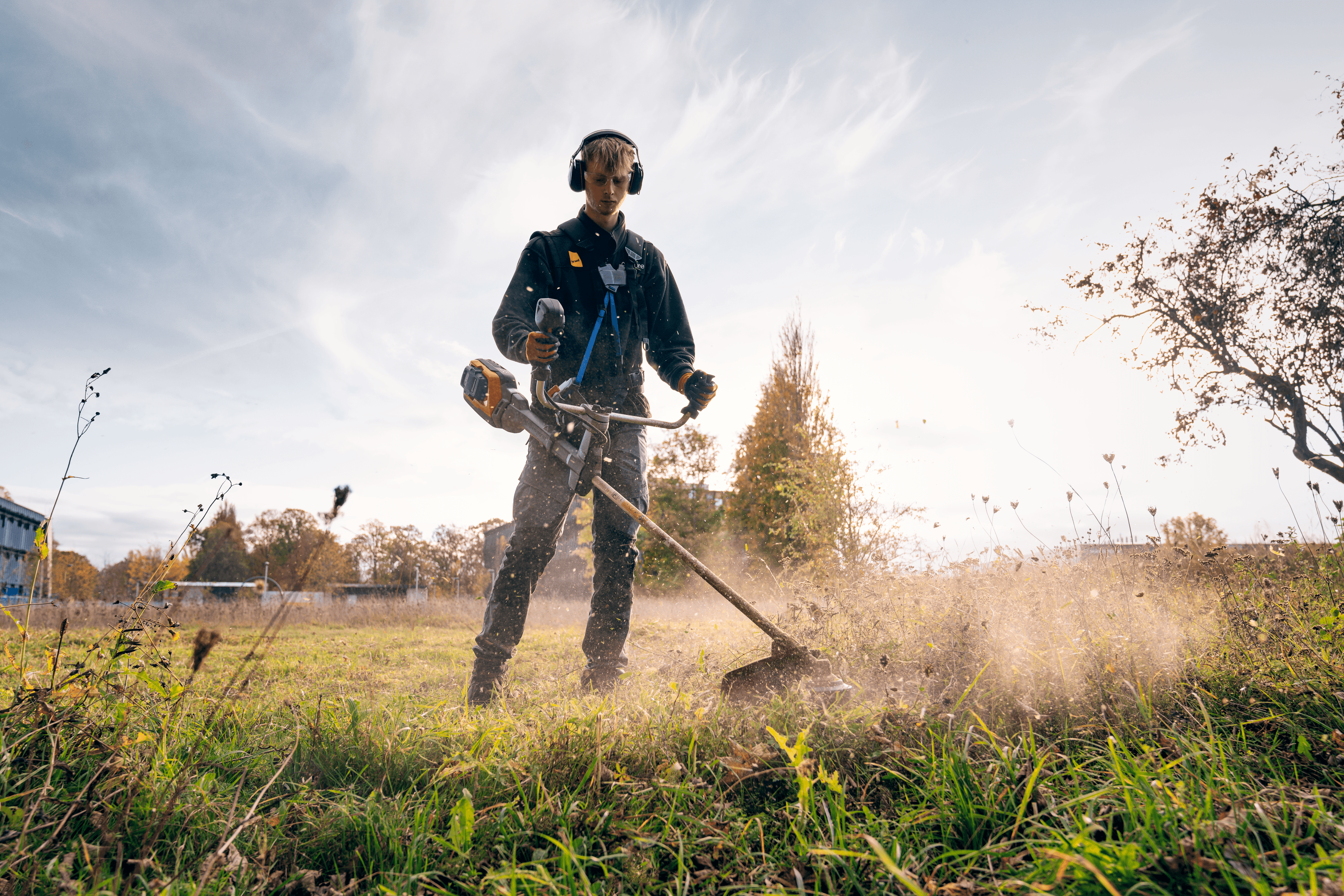 man wearing ppe with chainsaw